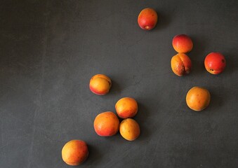 Wall Mural - fresh apricots, orange fruits, summer vitamins, small apricots on a dark background