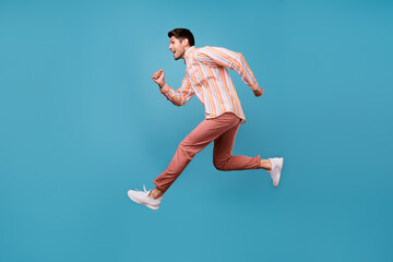 Poster - Full size profile side photo of young man happy positive smile jump run hurry sale isolated over blue color background