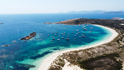 Aerial view of the beaches of Ses Illetes on the island of Formentera in the Balearic Islands, Spain - Turquoise waters on both sides of a sand strip in the Mediterranean Sea