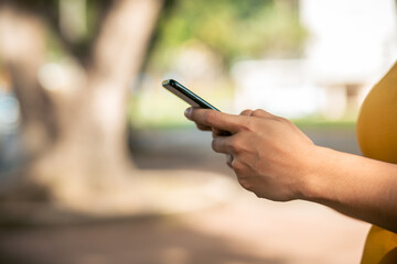 Poster - Closeup shot of a Hispanic person holding a phone in her hands