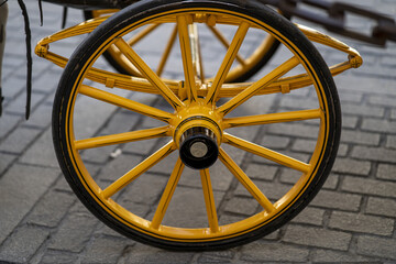 Sticker - Closeup shot of a yellow carriage wheel