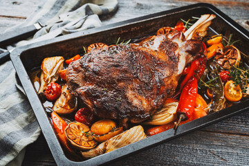 Wall Mural - Traditional barbecue lamb shoulder with vegetables and chili served as close-up on a rustic metal tray