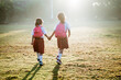 © Odua Images - two girl friend primary school student walking together