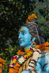 Wall Mural - Detail of the statue of Shiva, hindu idol on the ghat near the Ganges river in Rishikesh, India