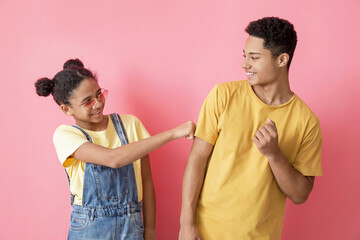 Wall Mural - African-American brother and sister on color background