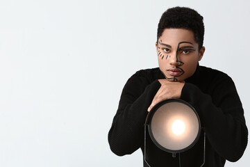 Sticker - Young African-American guy with paint on face against light background