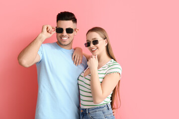 Sticker - Young couple wearing stylish sunglasses on color background