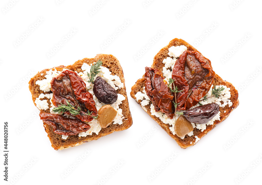 Tasty bruschettas with cheese, sun-dried tomatoes and dates on white background