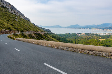 Poster - View of a highway road between green mountains, shores sea in background in Mallorca, Spain