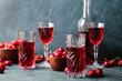 Composition with glasses of sweet cherry wine on color background