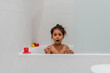 Little kid girl taking a shower