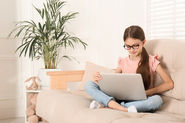 Canvas Print - Girl with laptop on sofa at home