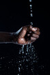 African man hands interacting with water.