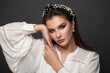 © millaf (Nemchinova) - Beautiful brunette woman in black headband and pearls earring on black background