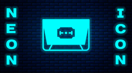 Poster - Glowing neon Blade razor icon isolated on brick wall background. Vector