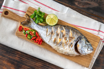 Wall Mural - Grilled fish on the wooden board