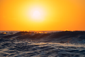 Wall Mural - Sea wave close up, low angle view, sunrise shot