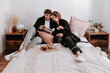 © ADDICTIVE STOCK - Content couple having breakfast together on bed