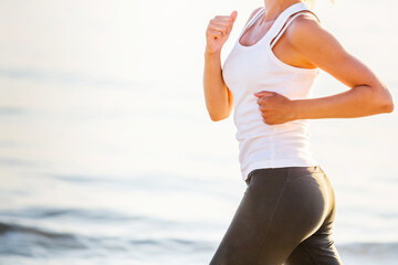 Wall Mural - Beautiful woman running by the sea