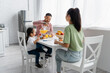 © LIGHTFIELD STUDIOS - happy asian family having breakfast in kitchen