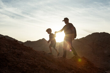Wall Mural - Dad with son in the mountains in the desert