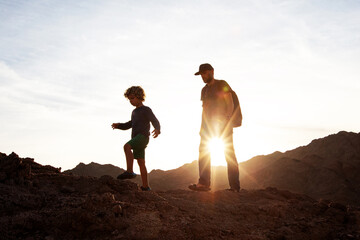 Wall Mural - Dad with son in the mountains in the desert