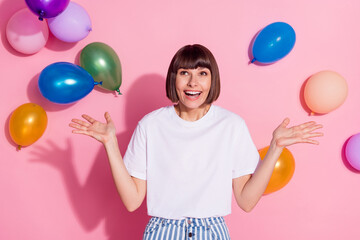 Wall Mural - Portrait of attractive amazed cheerful girl having fun weekend good mood air balls flying isolated over pink pastel color background