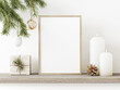 Vertical wooden frame mockup with hanging pine branch, pinecone, star, candles and gift box on rustic rough shelf. Minimal Christmas interior decoration. A4, A3 format. 3d rendering, illustration