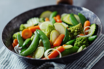 Vegan vegetables on pan on table