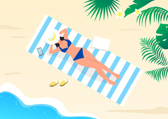 Wall Mural - A woman sunbathing on the beach.