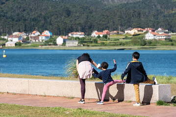 caucasian young woman and two children stretching for sport outdoor