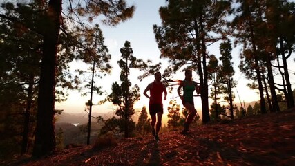 Wall Mural - Running fitness and health . Runners on run training during fitness workout outside in mountain forest at sunset. People jogging together living healthy active lifestyle outside. Woman and man