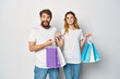 © SHOTPRIME STUDIO - young couple in white t-shirts with bags in hands shopping fun