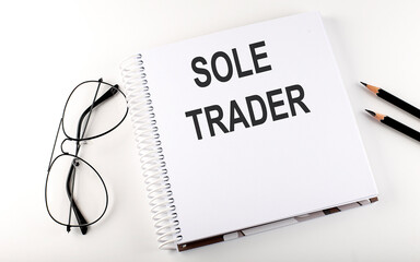 Poster - Notebook with text SOLE TRADER on the white background