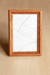 Glass with cracks on a wooden photo frame. Large. Vertically.