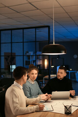 Poster - Business people working in office at night