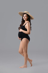 Wall Mural - Beautiful pregnant woman on grey background