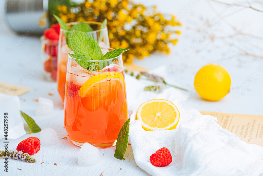 Cold drink. Orange drink with mint and fruits. Fresh drink in glass. Summer drink. Drink from beach bar. - obrazy, fototapety, plakaty 