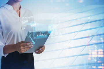 Poster - Businesswoman hand holds tablet device, blue hologram glowing di