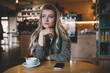 © BullRun - Female student sitting in cafe with cup of coffee
