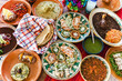 Traditional mexican dishes sopes, tacos dorados, tortillas, mole poblano, red rice, rajas poblanas, beans, pipian, salsa verde in Mexico City