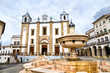 Fountain and Santo Antao Church at Giraldo Square in Evora, Portugal