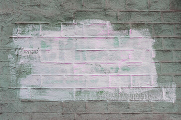 Old brick wall painted with two colors. Textured wall surface.