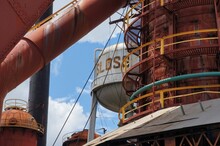 Sloss Furnaces Water Tower With Rusty Buildings And Silos