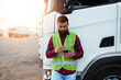 © hedgehog94 - Young handsome bearded man standing in font of his truck and using phone.