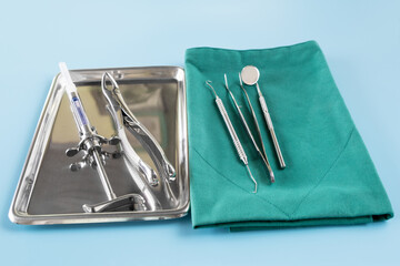 Wall Mural -  Dentistry medical tools forcept upper/ lower on blue background.