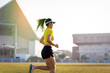 © EduLife Photos - A young Asian woman athlete runner jogging on running track in city stadium in the sunny morning to keep fitness and healthy lifestyle. Young fitness woman runs on stadium track. Sport and recreation