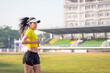 © EduLife Photos - A young Asian woman athlete runner jogging on running track in city stadium in the sunny morning to keep fitness and healthy lifestyle. Young fitness woman runs on stadium track. Sport and recreation