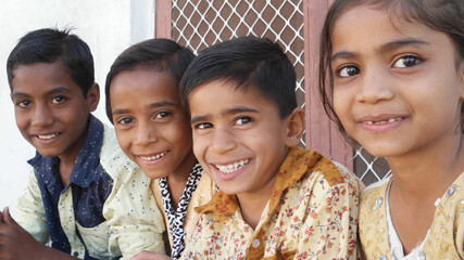 Group of Indian siblings smiling and looking at the camera