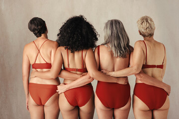 Wall Mural - Shot of four anonymous women embracing their natural bodies